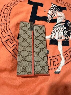 Gucci Beige Monogram Bifold Wallet with Red Trim never use light marks on metal